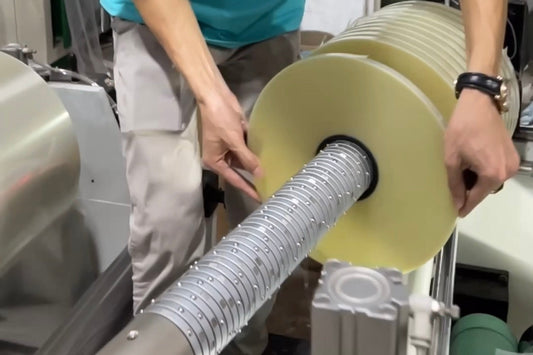 XW Machiniery Differential Shaft installed on a slitting and rewinding machine for precise multi-roll tension control and uniform winding quality.